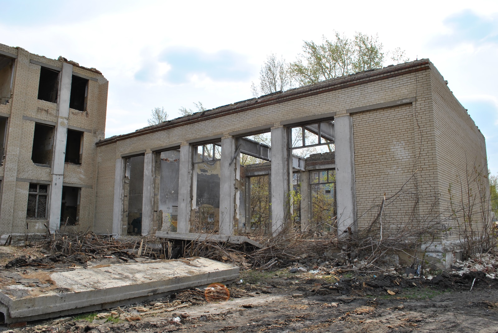 a run down building with broken windows and rubble