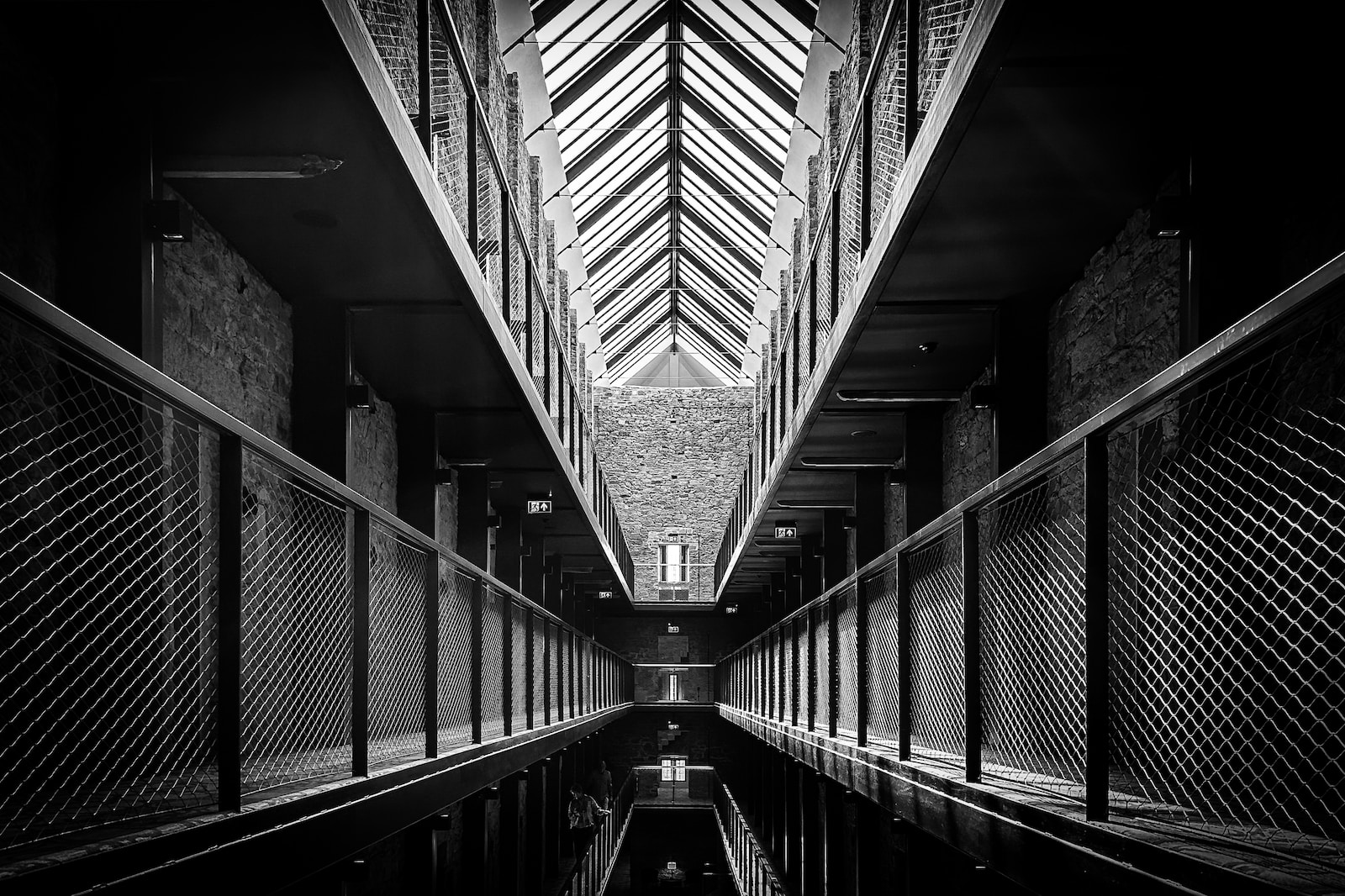 a black and white photo of a long hallway